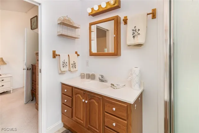 a bathroom with a sink vanity and mirror