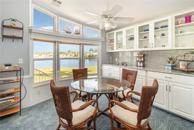 a dining room with furniture a chandelier and wooden floor