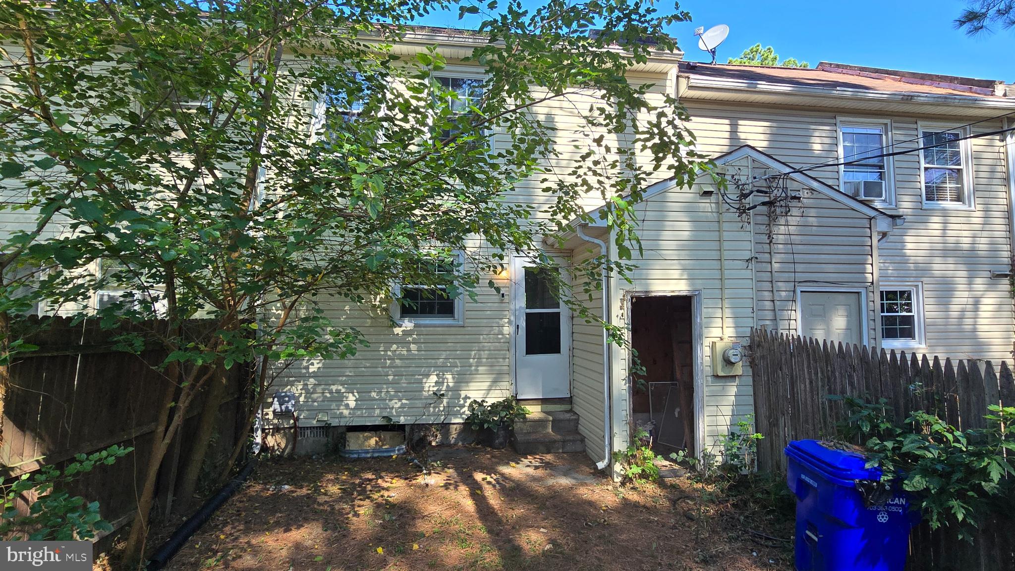 Fenced rear yard with storage closet.