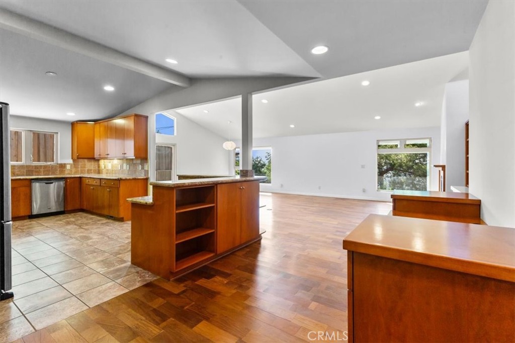 2377 Silver Ridge Avenue Los Angeles, CA 90039 - Photo 13 of 46 a kitchen with stainless steel appliances kitchen island granite countertop a large counter top and a wooden floors