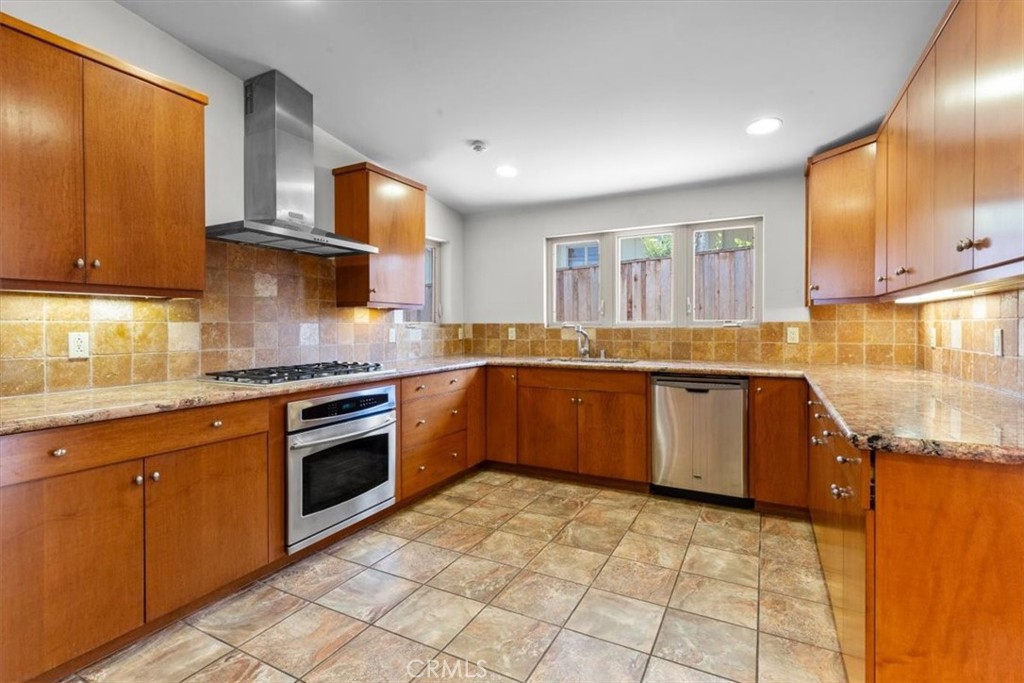 2377 Silver Ridge Avenue Los Angeles, CA 90039 - Photo 23 of 46 a kitchen with stainless steel appliances granite countertop a stove sink and cabinets
