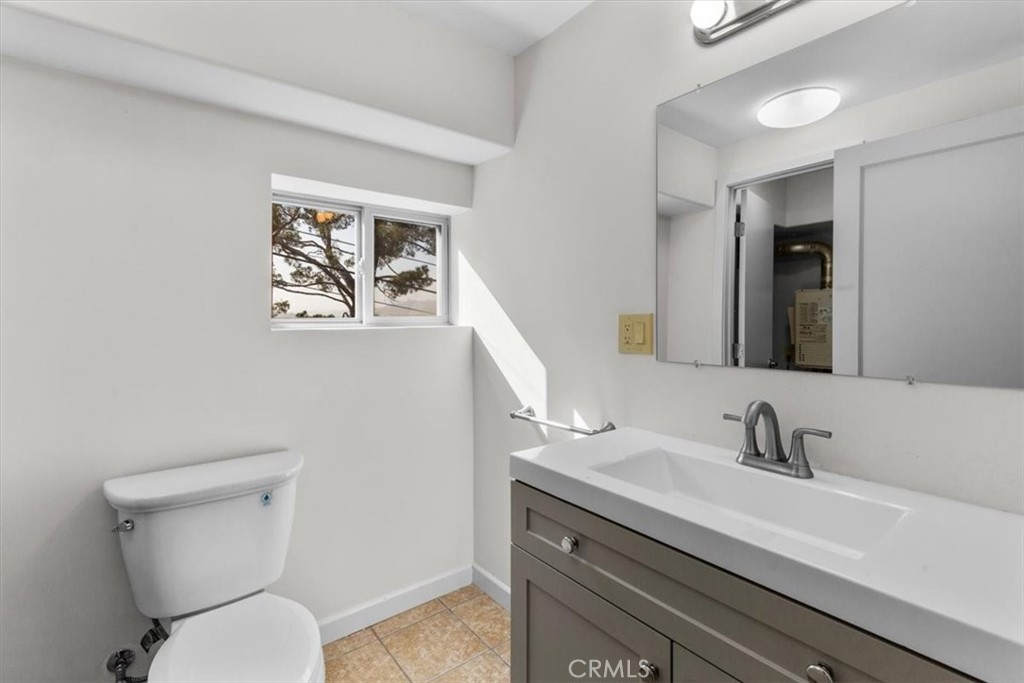 2377 Silver Ridge Avenue Los Angeles, CA 90039 - Photo 42 of 46 a bathroom with a toilet a sink and mirror