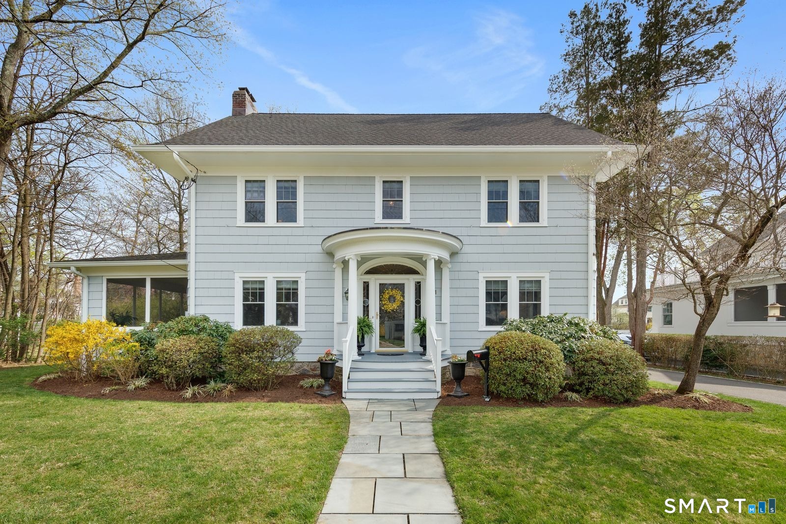 a front view of a house with a garden