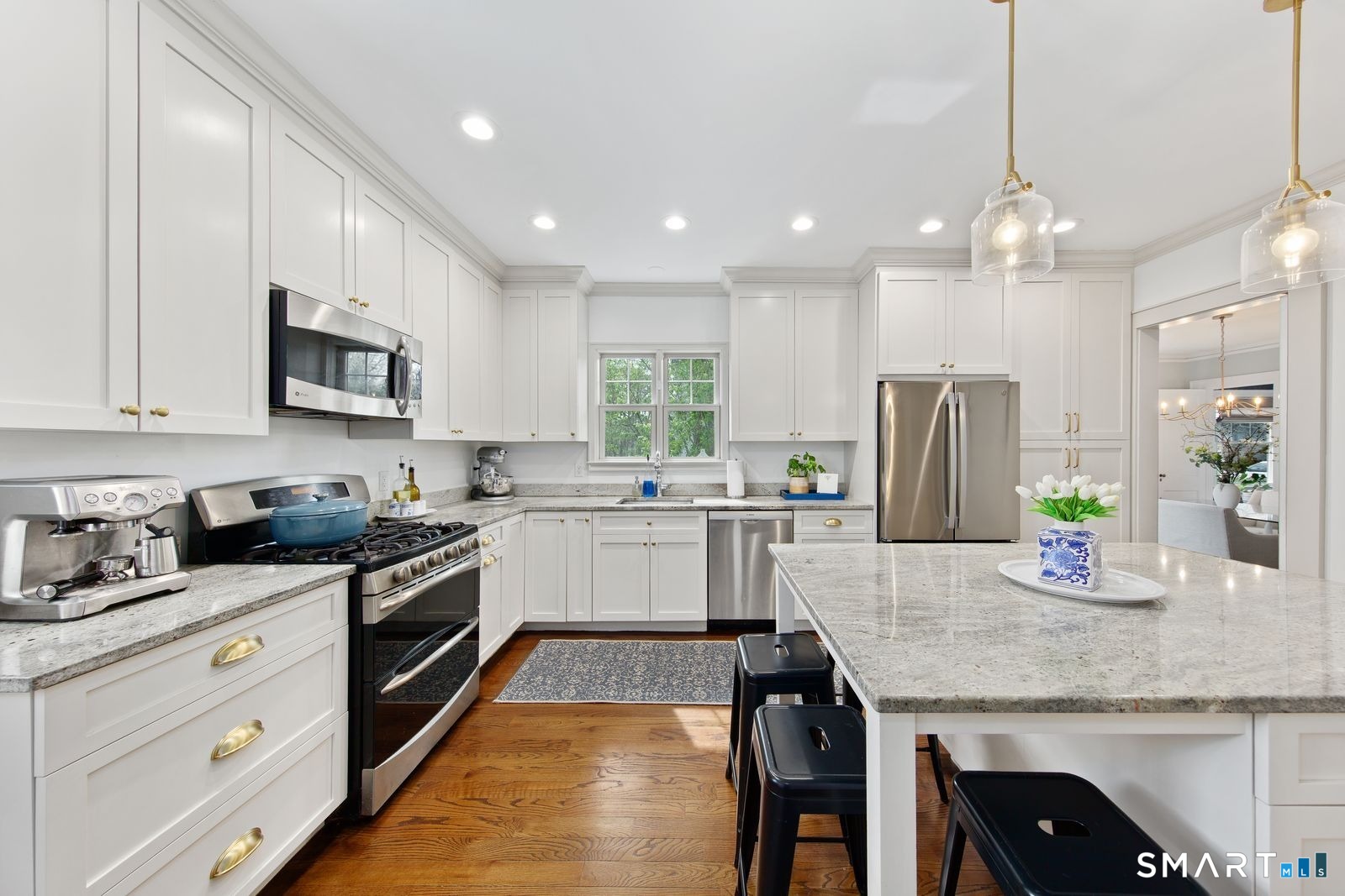 41 Chester Street Stamford, CT 06905 - Photo 16 of 40 a kitchen with granite countertop kitchen island stainless steel appliances a sink a stove a refrigerator cabinets and chairs