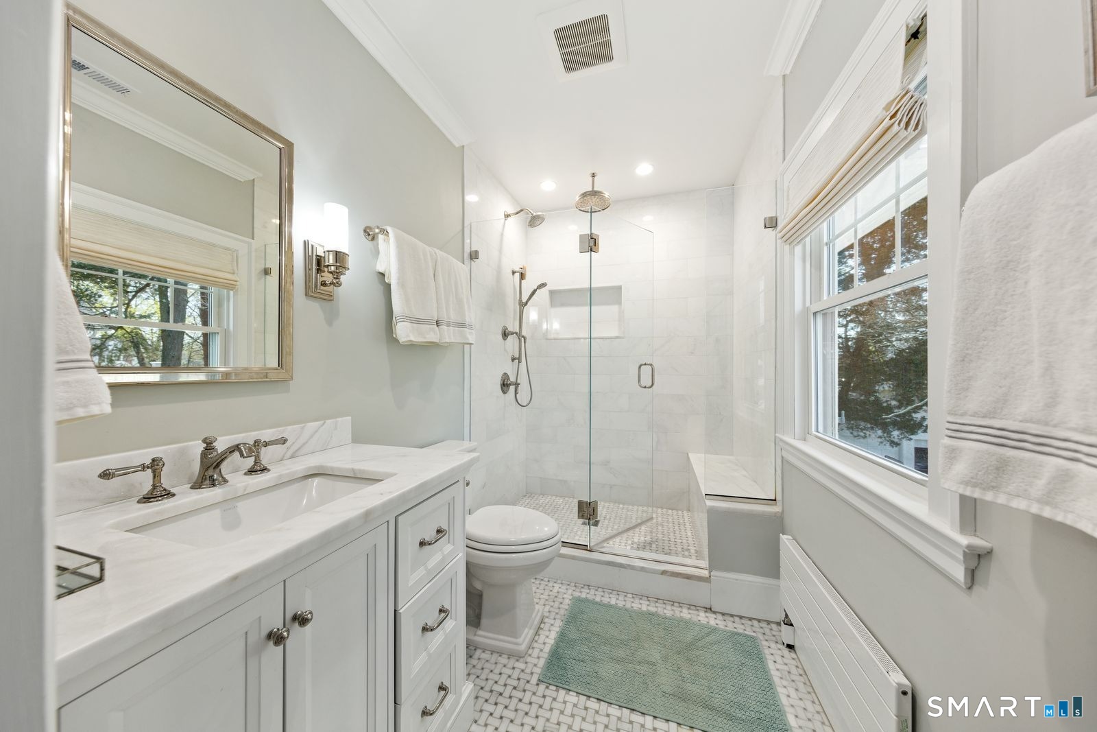41 Chester Street Stamford, CT 06905 - Photo 23 of 40 a bathroom with a sink a toilet a large mirror and shower