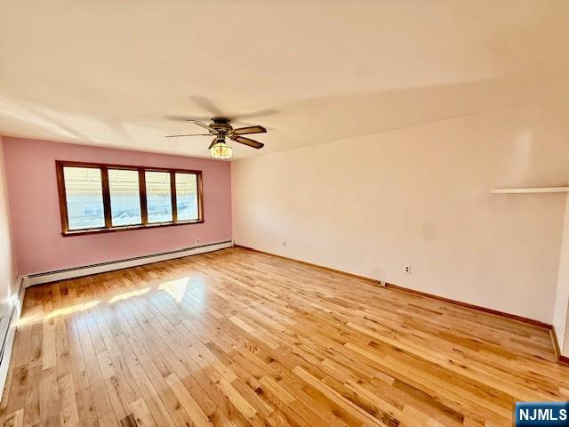 46 Frances Street, Unit 2 Clifton, NJ 07014 - Photo 2 of 8 a view of a livingroom with wooden floor and a window