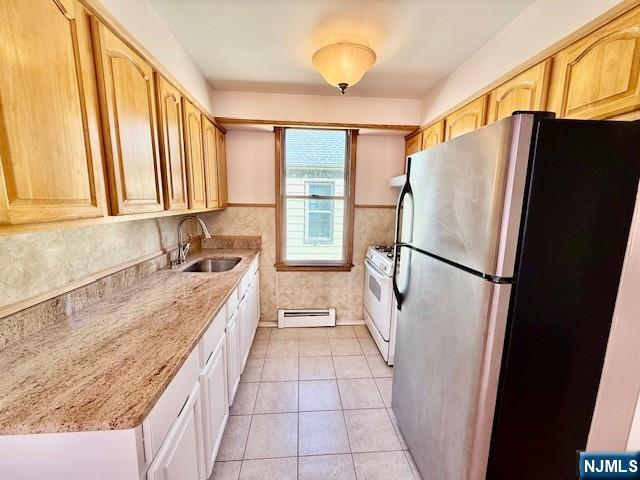 46 Frances Street, Unit 2 Clifton, NJ 07014 - Photo 5 of 8 a kitchen with granite countertop a refrigerator and a sink