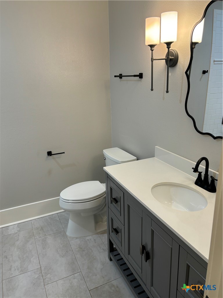 110 Hiram Cook Blanco, TX 78606 - Photo 19 of 46 a bathroom with a sink a toilet and mirror