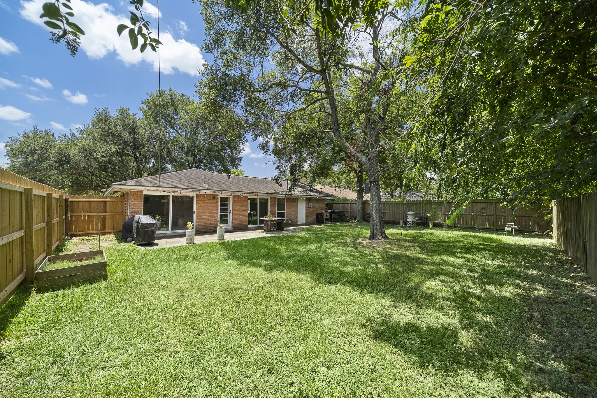 4306 Warm Springs Road Houston, TX 77035 - Photo 35 of 36 Picture from 2023. added Shade cover for patio and tree in middle removed