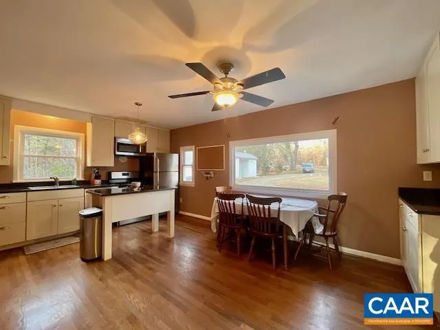 a view of a dining room with furniture window and wooden floor