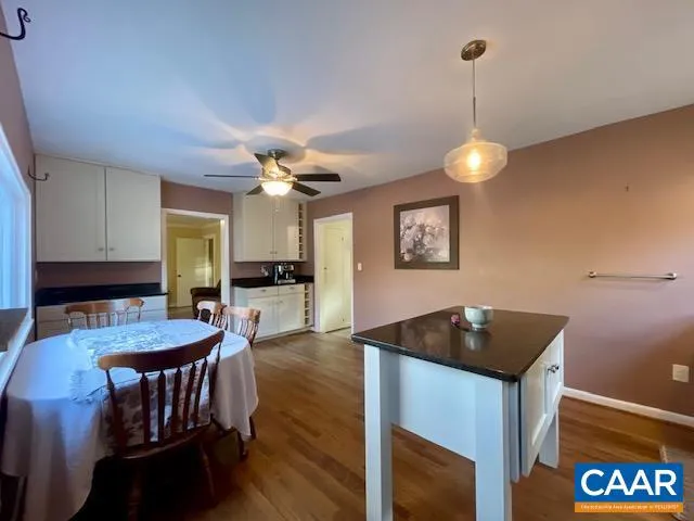 a kitchen with a table chairs and a chandelier