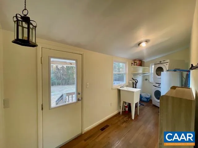 a view of a workspace with furniture and wooden floor