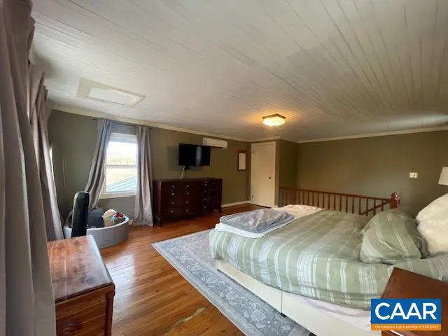 a bed room with a bed and a television