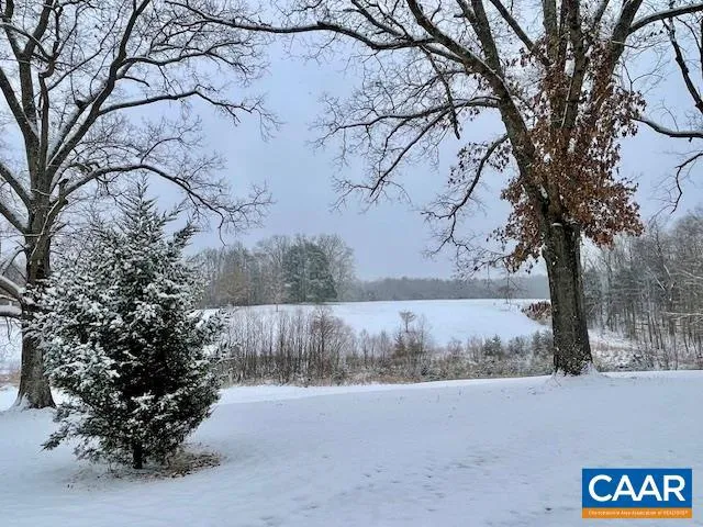 a view of a yard with wooden fence
