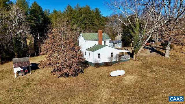a view of a backyard with chairs and a table