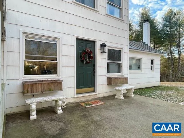 a house view with a sitting space and wooden fence