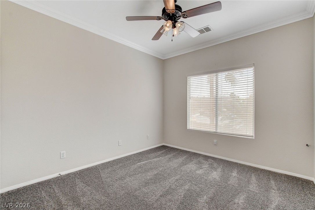191 Verde Ridge Court Henderson, NV 89012 - Photo 24 of 36 Carpeted empty room with baseboards, crown molding, and a ceiling fan