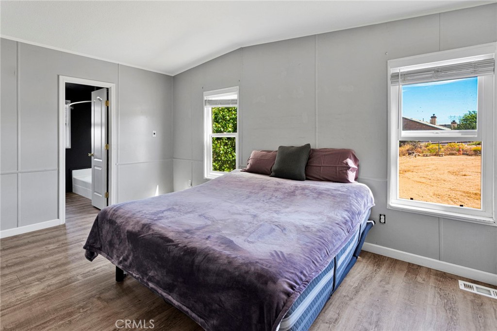 8074 Mira Mar Road Phelan, CA 92371 - Photo 29 of 49 a bedroom with a bed and window