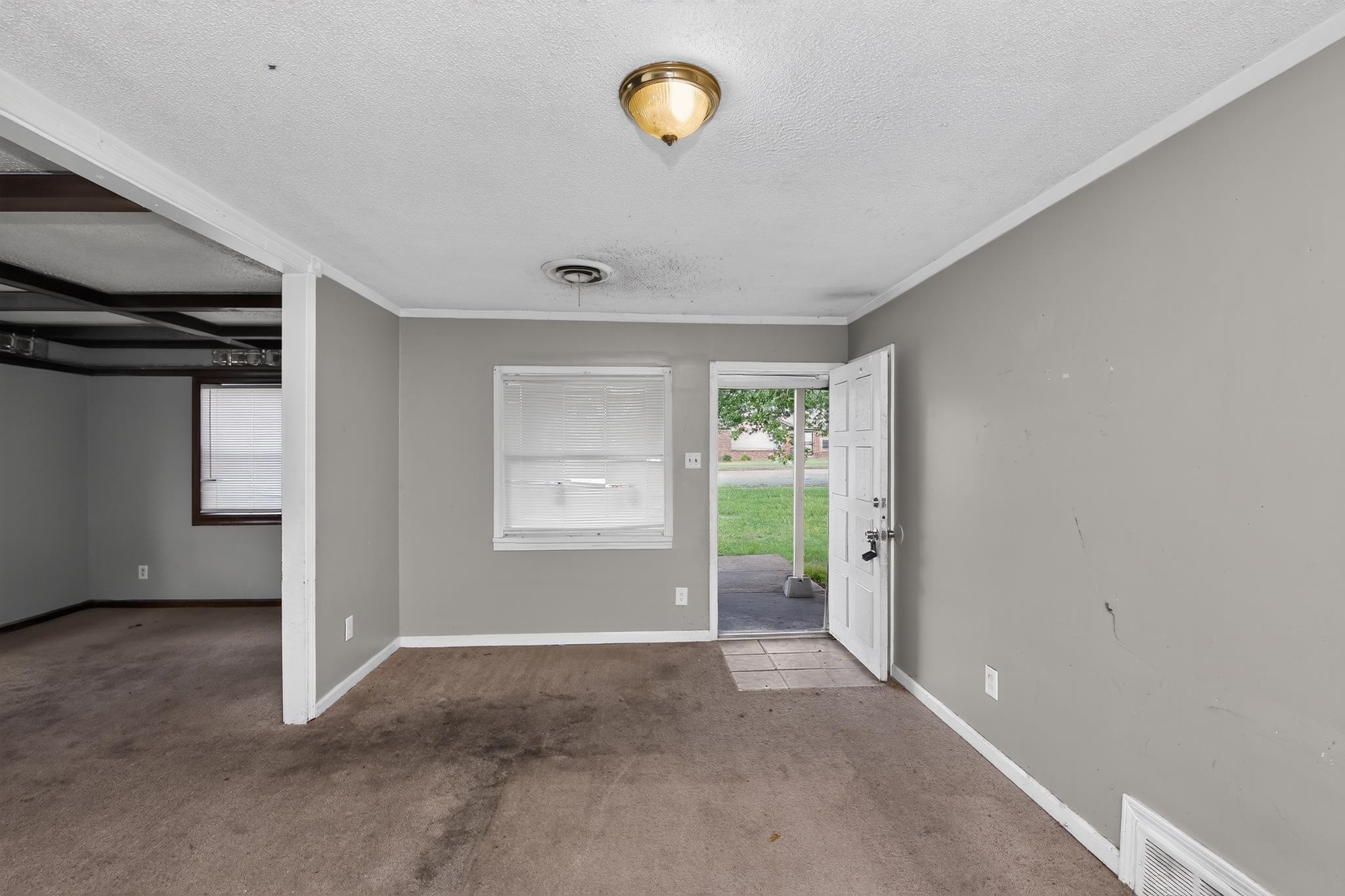 3791 Windermere Road Memphis, TN 38128 - Photo 7 of 18 Entry room featuring a ceiling-mounted light fixture, neutral-toned walls, and a visible doorway to an additional room