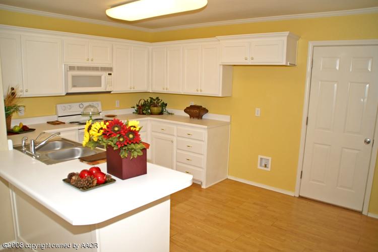 3617 South Mirror Street Amarillo, TX 79118 - Photo 5 of 15 a kitchen with a sink a stove and cabinets