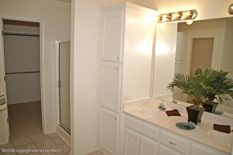 3617 South Mirror Street Amarillo, TX 79118 - Photo 7 of 15 a bathroom with a sink a mirror and shower