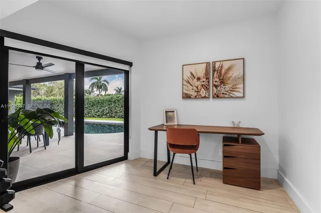 a bedroom with furniture and a large window