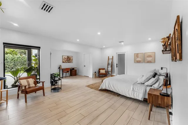 a bedroom with furniture and a rug