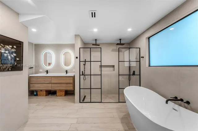 a spacious bedroom with two bed and a large window