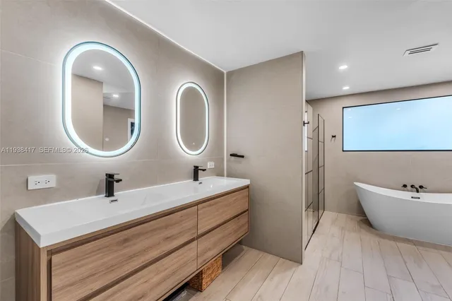 a bedroom with a large bed and a large window