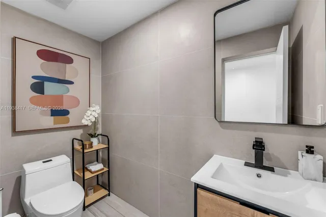 a bathroom with a sink toilet a mirror and shower