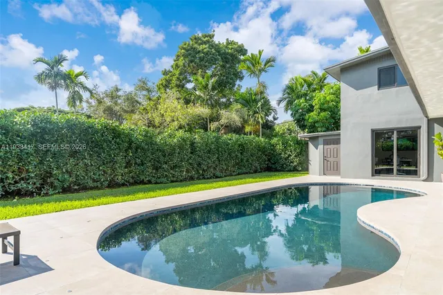 a living room with furniture and floor to ceiling windows