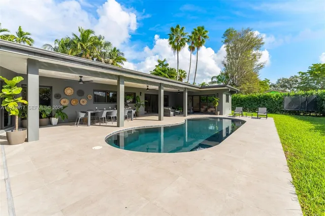a view of a swimming pool with an outdoor space and seating area