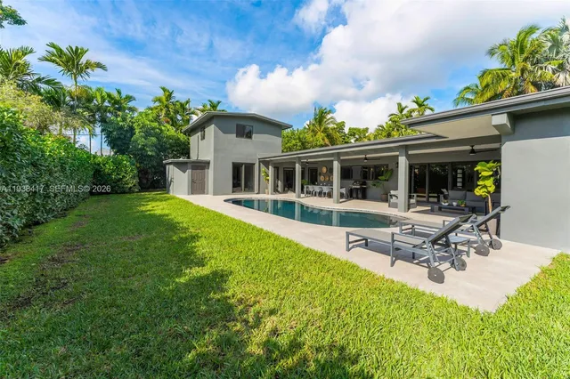 an aerial view of residential houses with outdoor space and street view