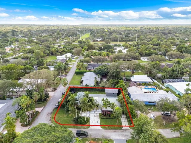 an aerial view of residential houses with outdoor space and street view