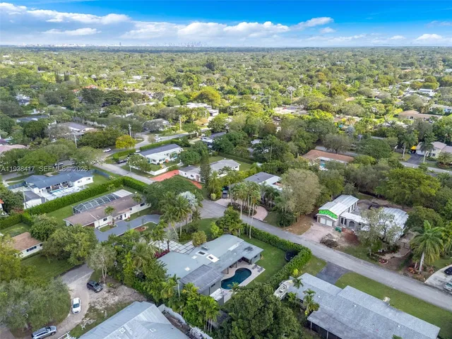 an aerial view of residential houses with outdoor space and river