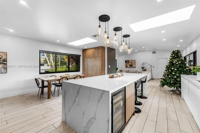 a large white kitchen with lots of counter space and furniture