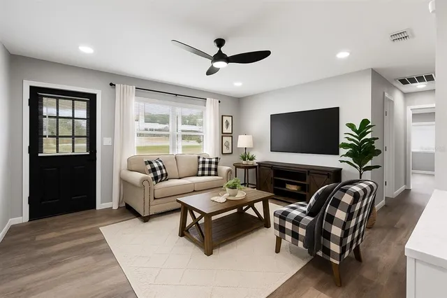 a living room with furniture and a flat screen tv