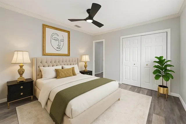 a bedroom with a bed and a potted plant