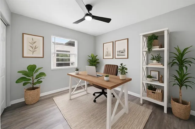 a view of a workspace with furniture and a potted plant
