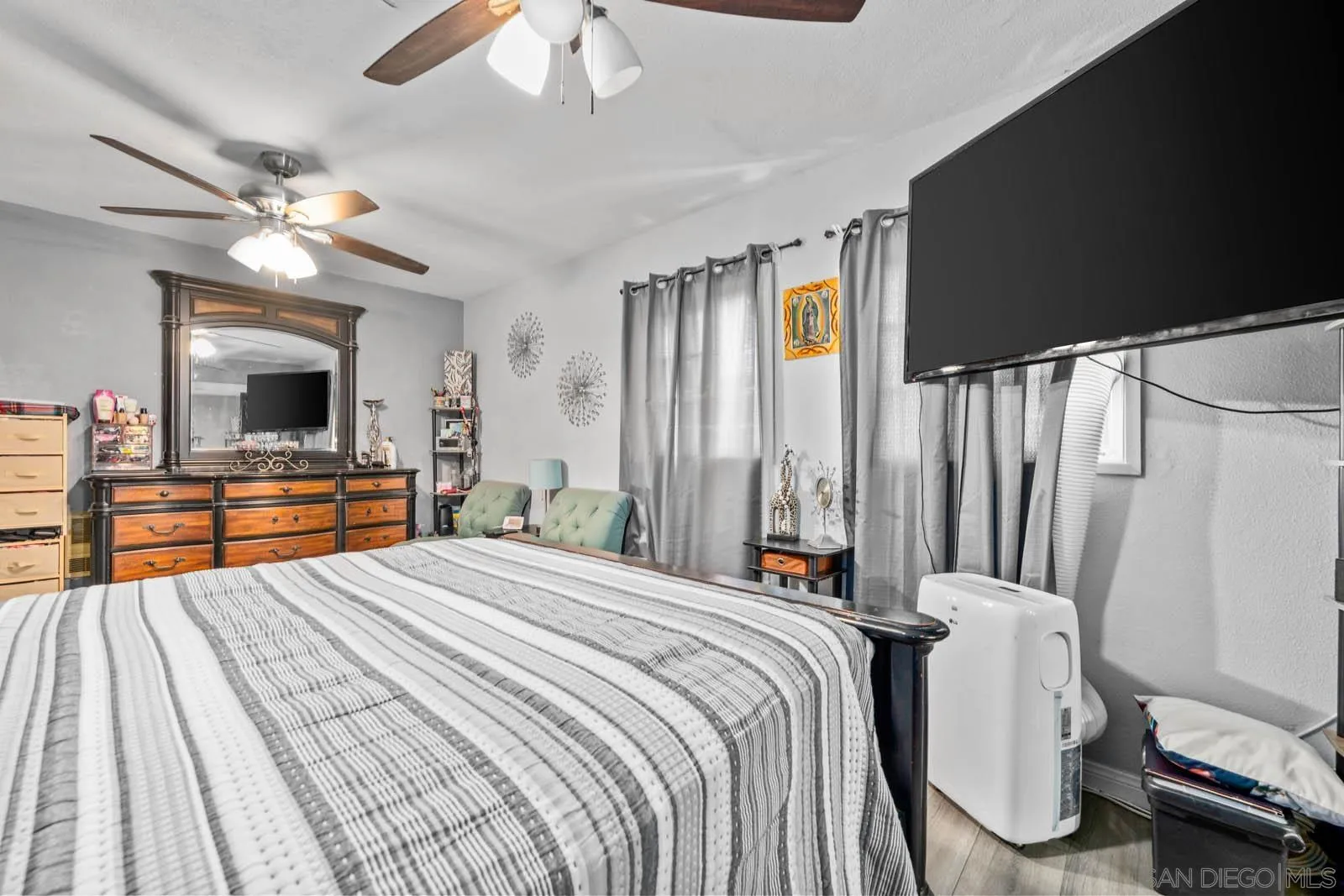 124 East View Street Fallbrook, CA 92028 - Photo 20 of 50 a bedroom with a bed dresser and a flat tv screen