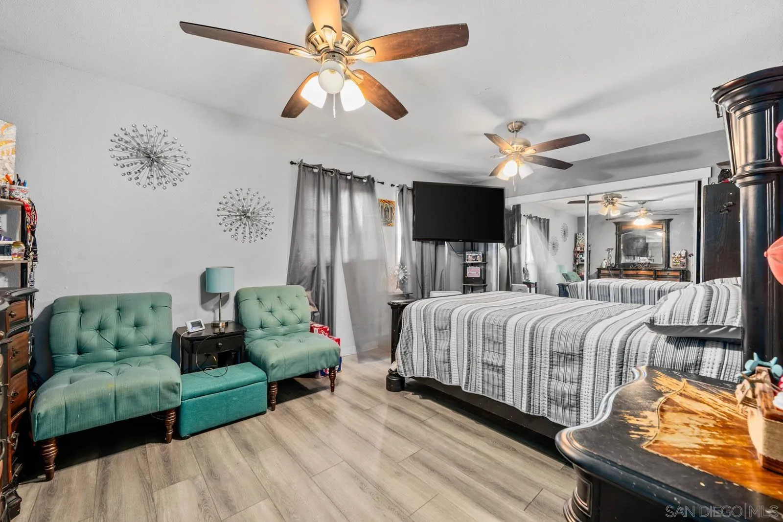 124 East View Street Fallbrook, CA 92028 - Photo 21 of 50 a spacious bedroom with a bed a couch and a chandelier