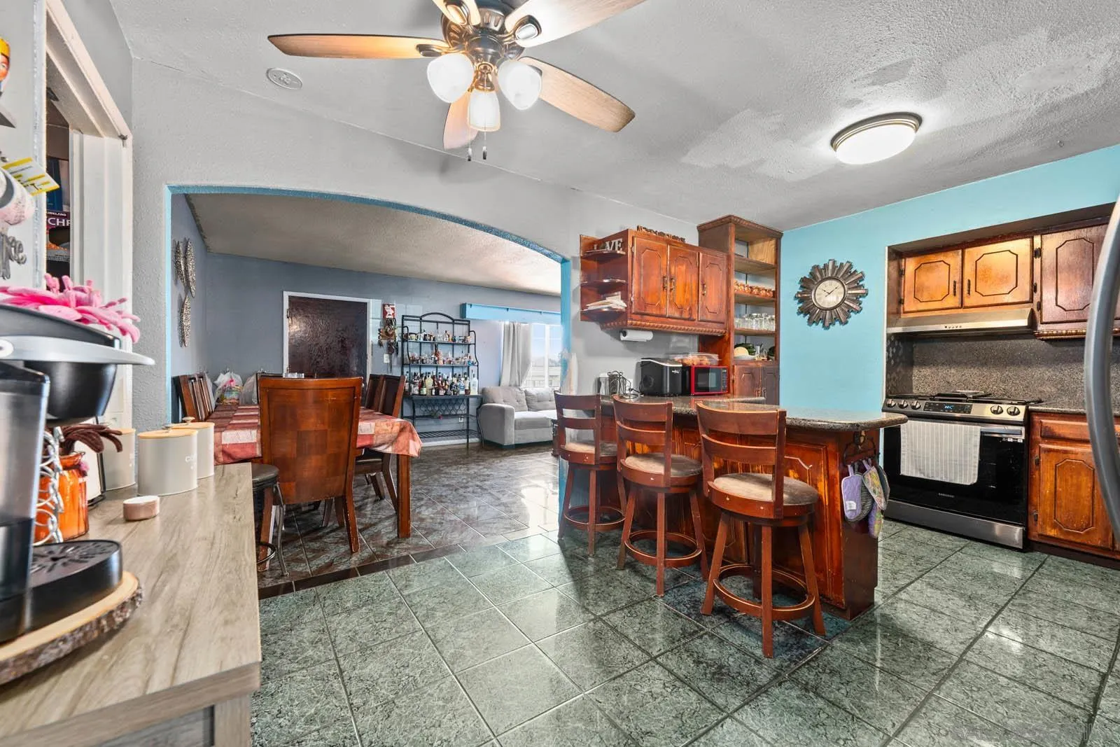 124 East View Street Fallbrook, CA 92028 - Photo 3 of 50 a living room with furniture a flat screen tv and kitchen view