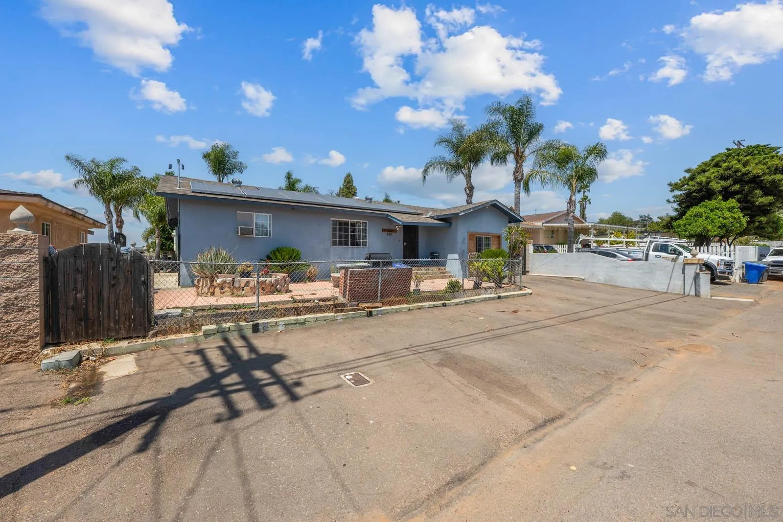 124 East View Street Fallbrook, CA 92028 - Photo 34 of 50 a view of a patio with dining table and chairs with wooden fence