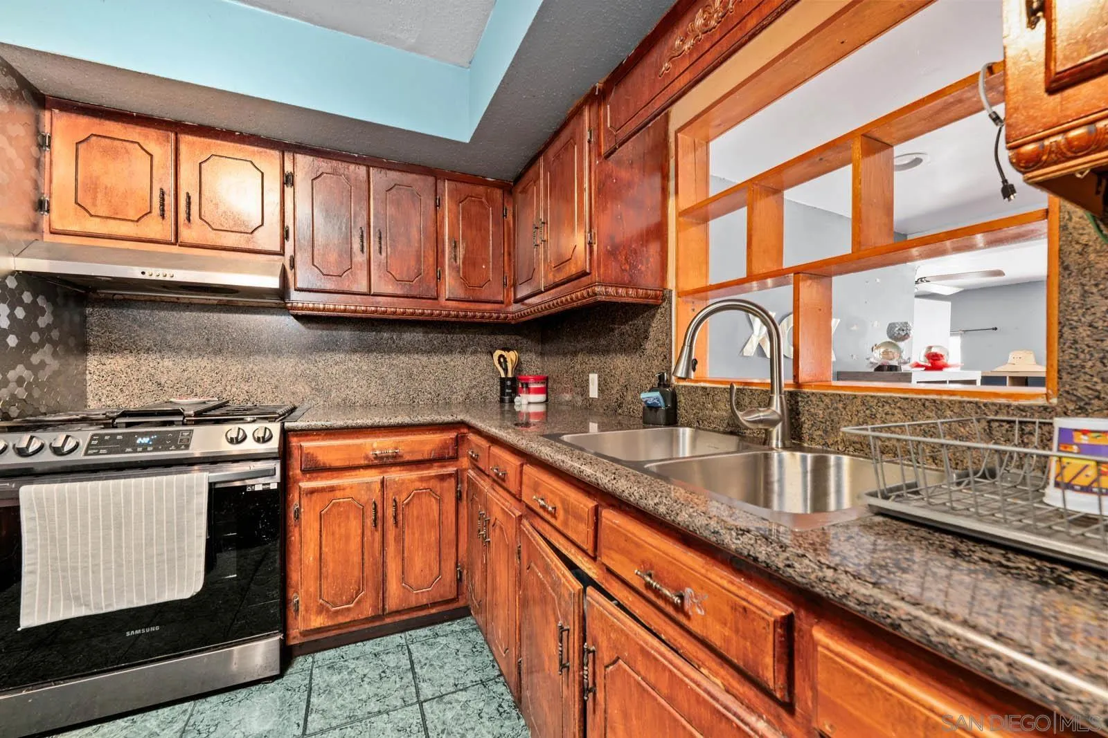 124 East View Street Fallbrook, CA 92028 - Photo 7 of 50 a kitchen with stainless steel appliances granite countertop a sink stove and cabinets