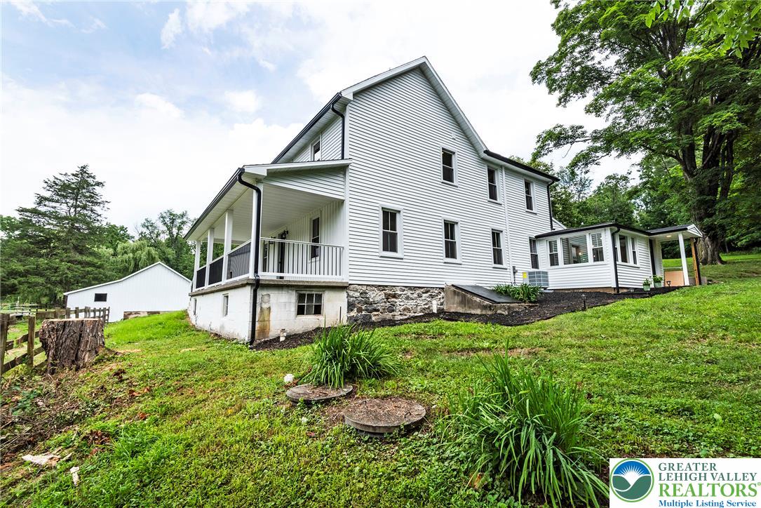 72 Allegheny Road Mount Bethel, PA 18343 - Photo 48 of 72 A classic farmhouse exterior with a welcoming porch and abundant green space.