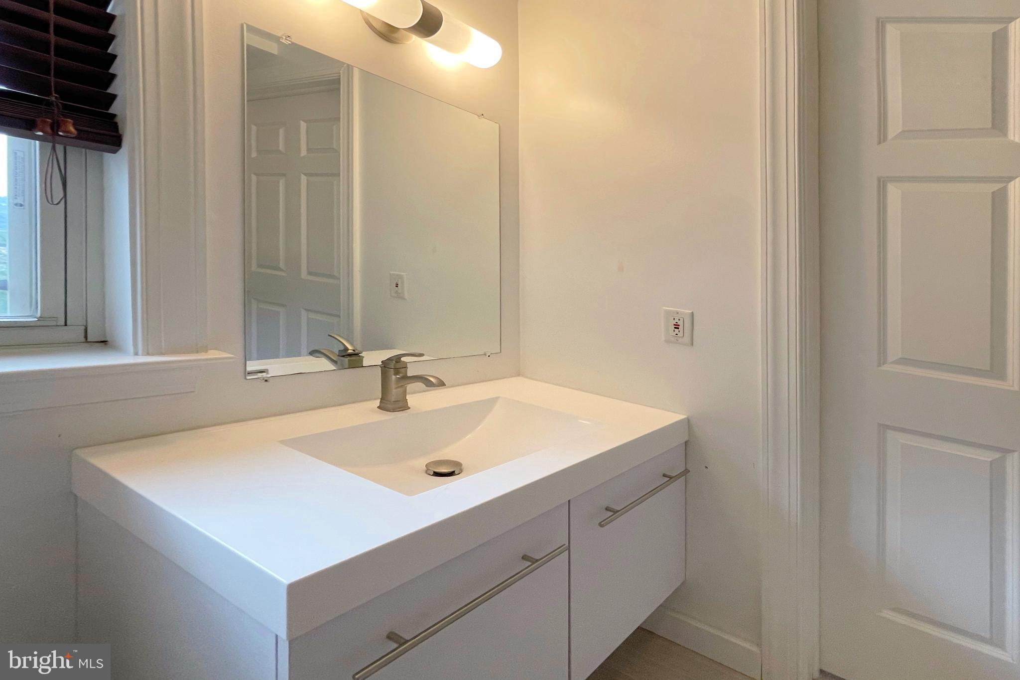 1555 North Colonial Terrace, Unit 600 Arlington, VA 22209 - Photo 23 of 29 a bathroom with a sink and a mirror