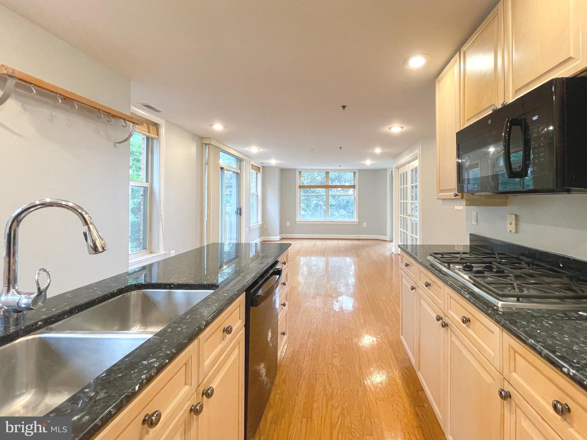 1555 North Colonial Terrace, Unit 600 Arlington, VA 22209 - Photo 10 of 29 a kitchen with granite countertop a sink a stove and cabinets