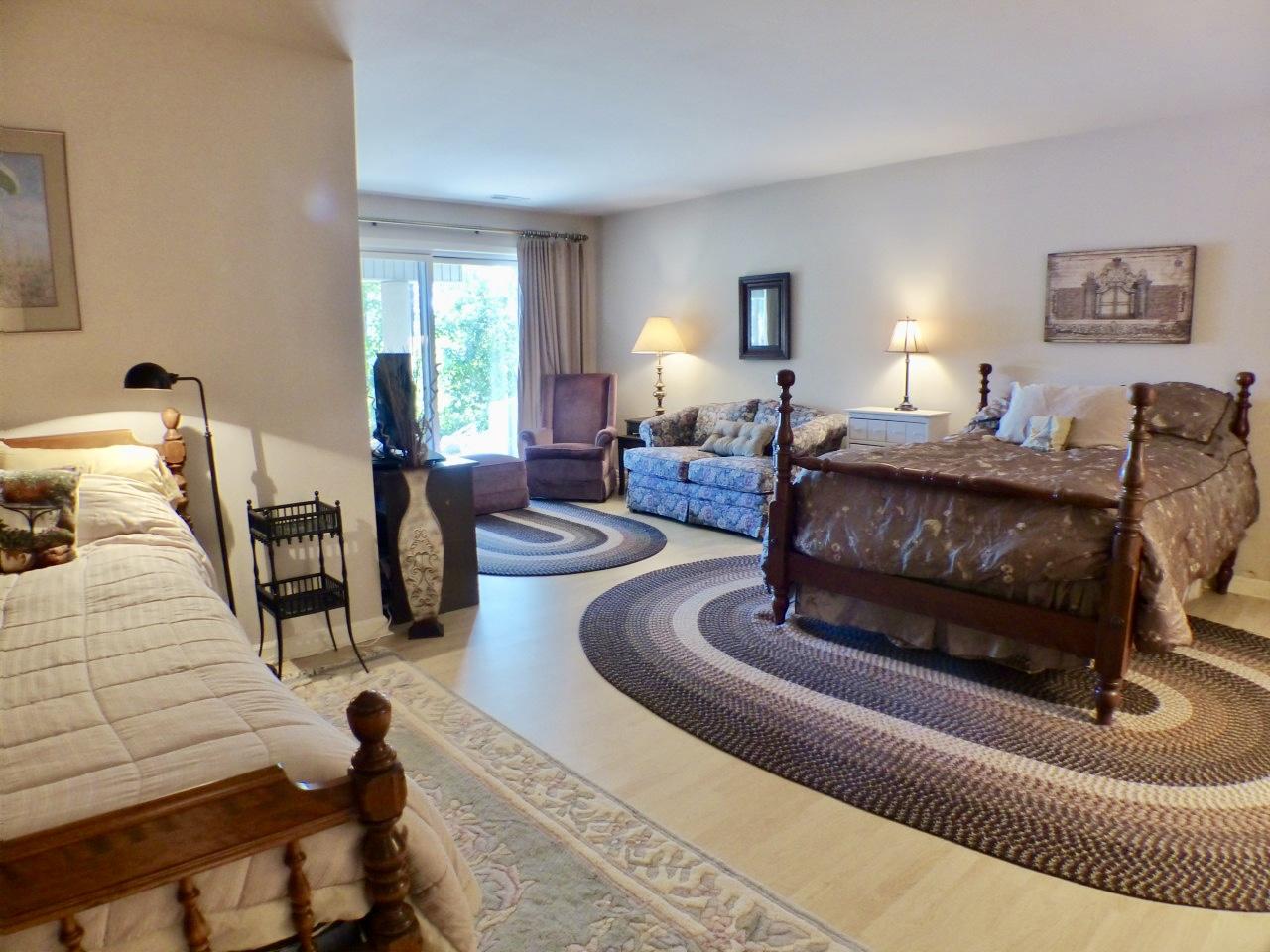 1100 Burning Tree Road Pinehurst, NC 28374 - Photo 17 of 28 Downstairs you will find a large bedroom that is large enough for a sitting area, and opens onto the patio for enjoying the lake views.