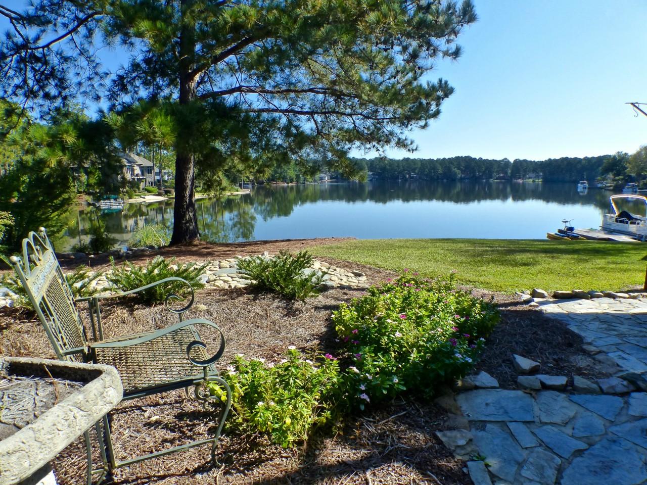 1100 Burning Tree Road Pinehurst, NC 28374 - Photo 22 of 28 There are wonderful lake views from the outside seating areas at this home.