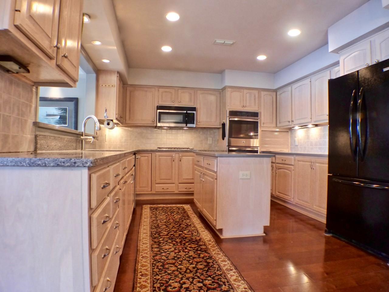 1100 Burning Tree Road Pinehurst, NC 28374 - Photo 6 of 28 This kitchen has solid surface counter tops, a center island and a breakfast bar.